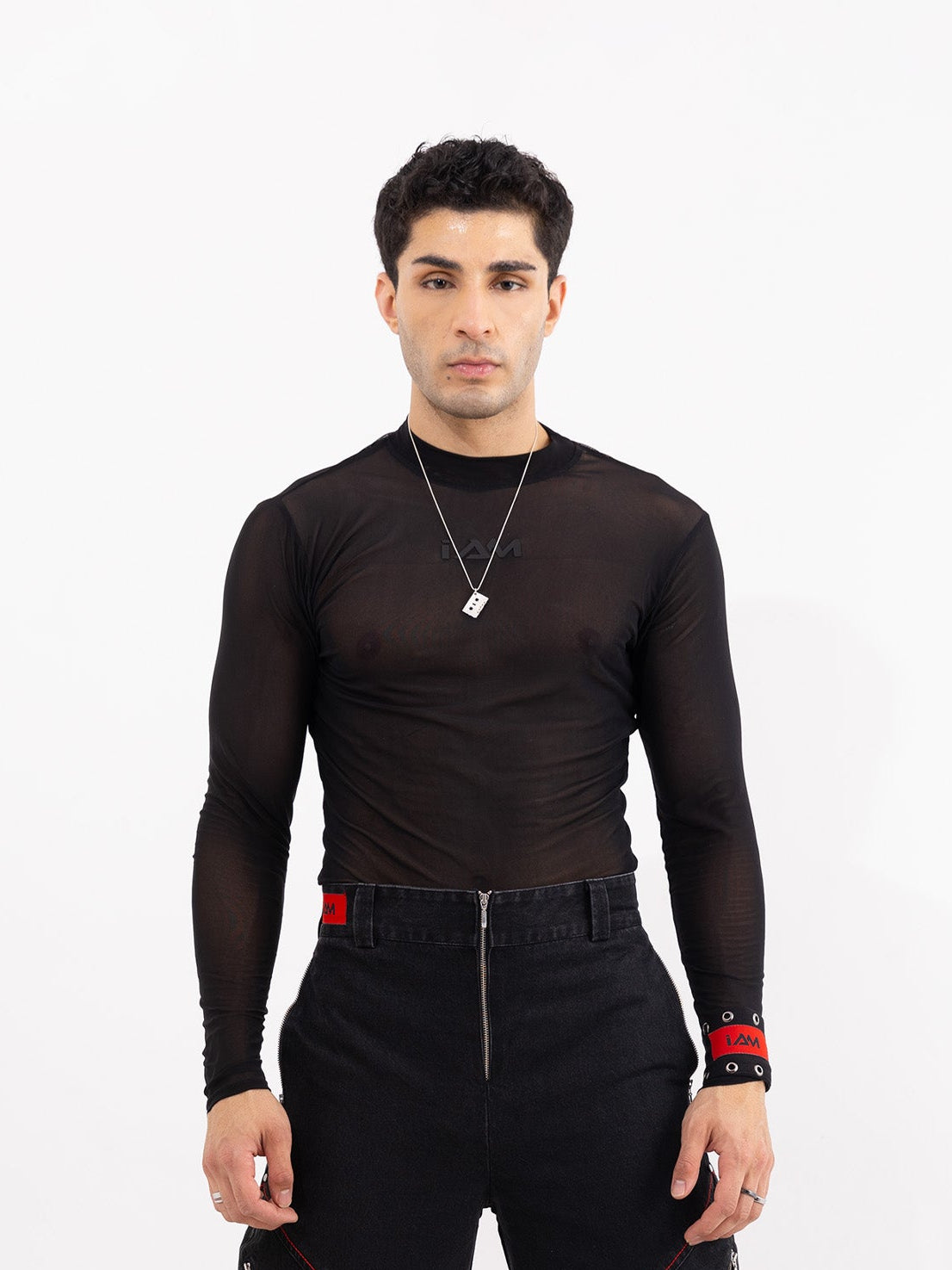 Black mesh top with long sleeves, showcasing a sheer, textured fabric.