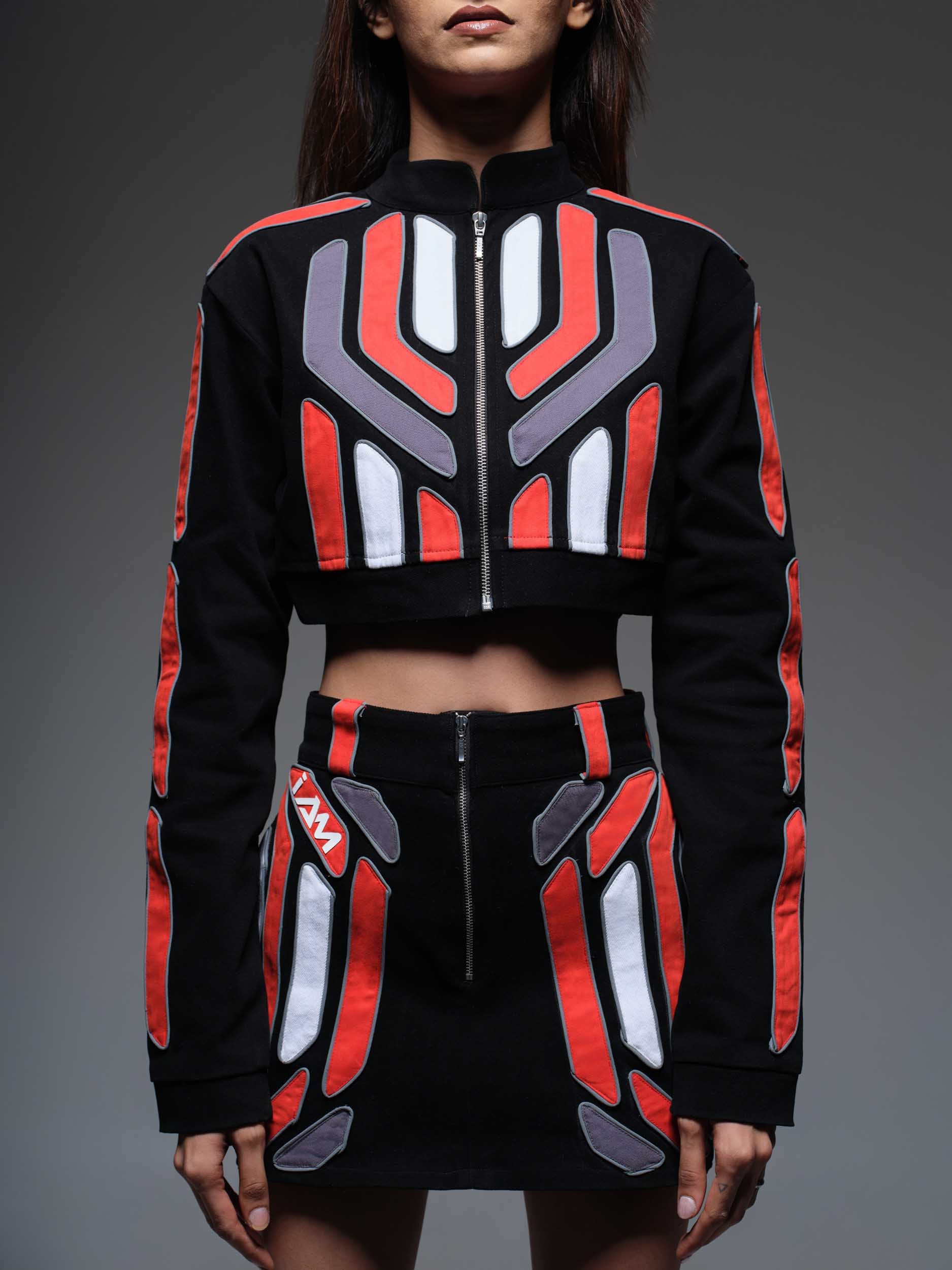 A close-up of the Red Domino Skirt, showcasing its vibrant red fabric and a repeating white domino pattern.