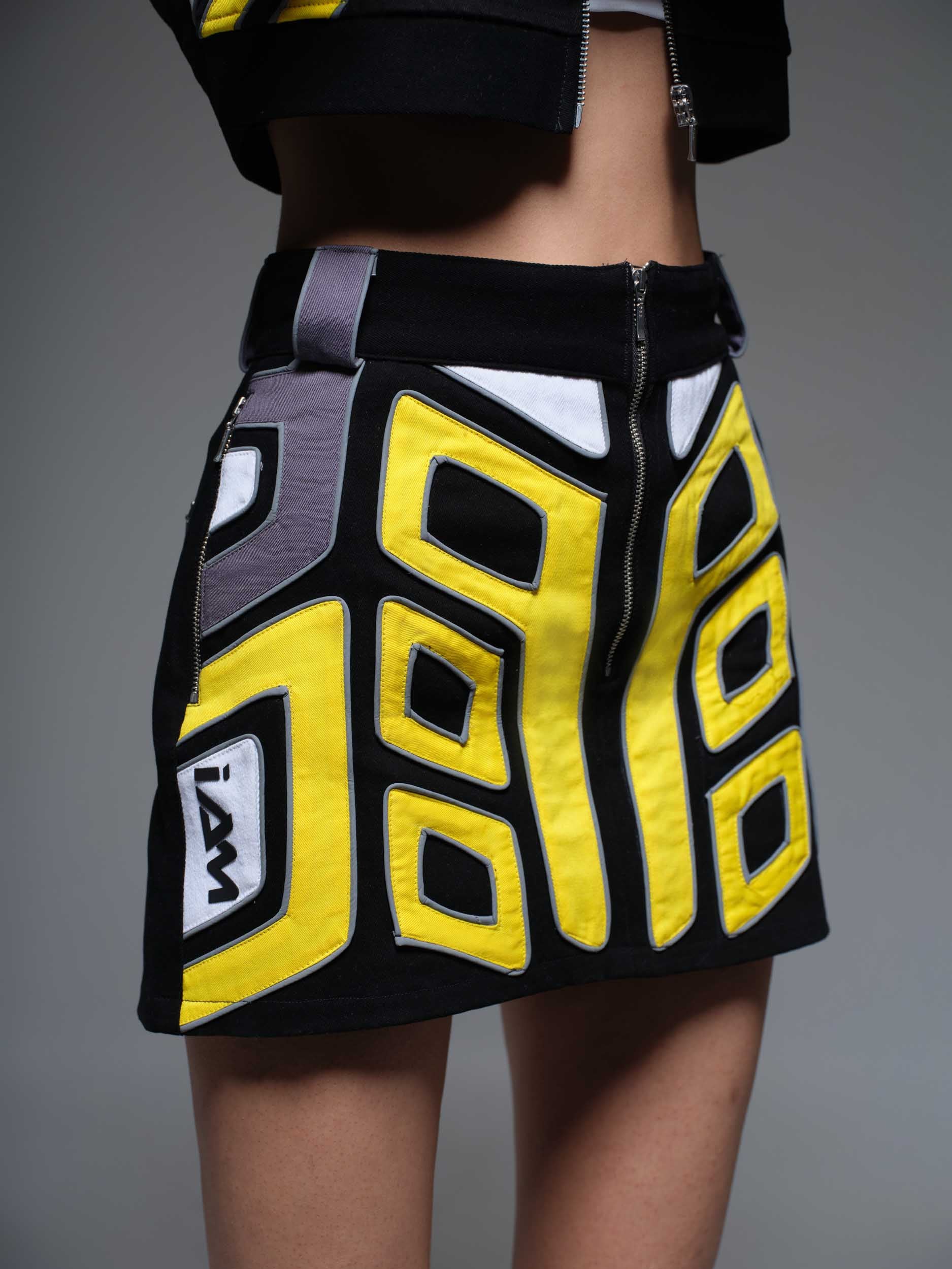 The Overdrive Skirt is a black, high-waisted, A-line mini skirt with a subtle texture.