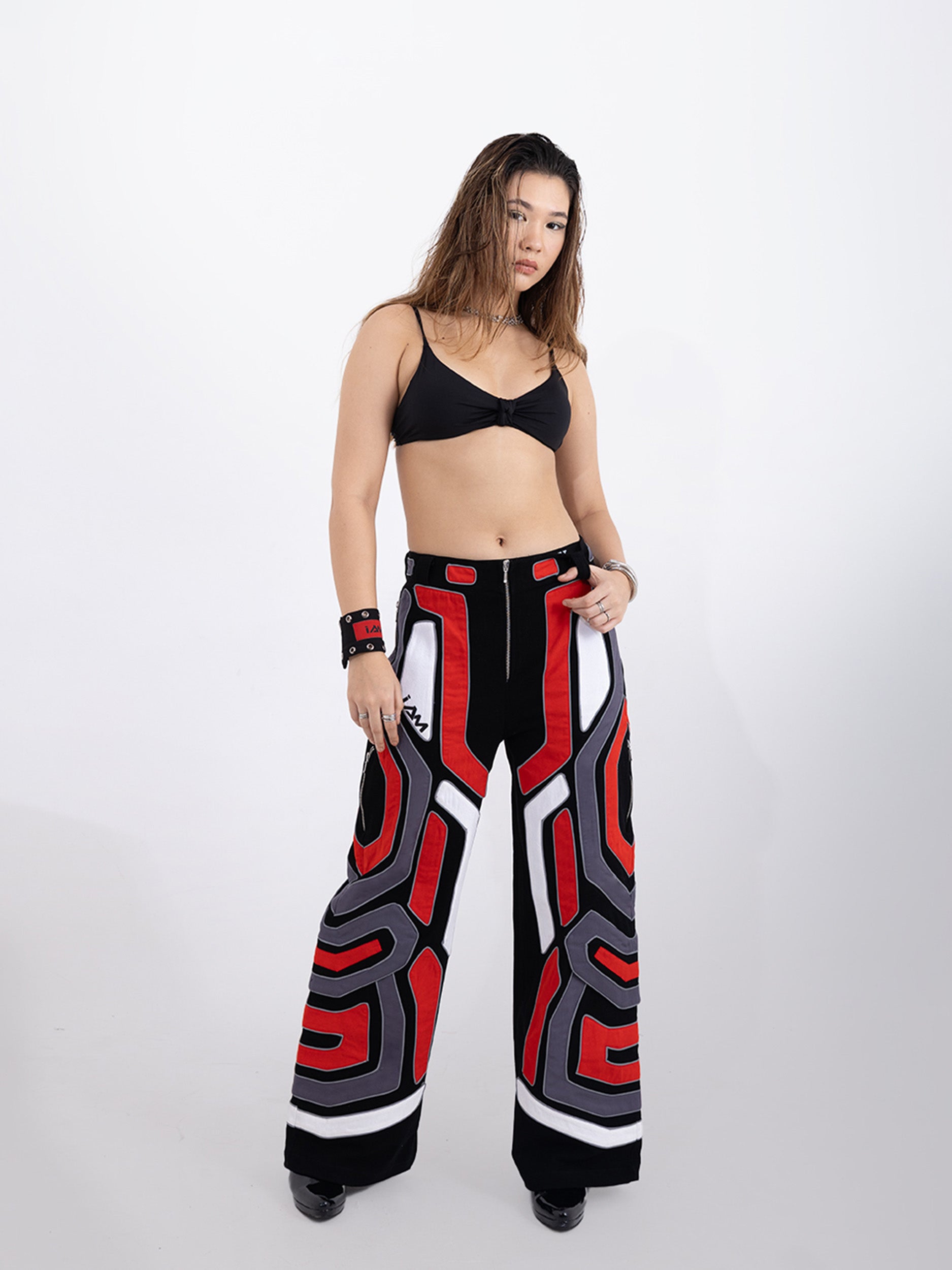 Red Domino Pants - Close-up of bright red pants with a subtle white domino pattern.