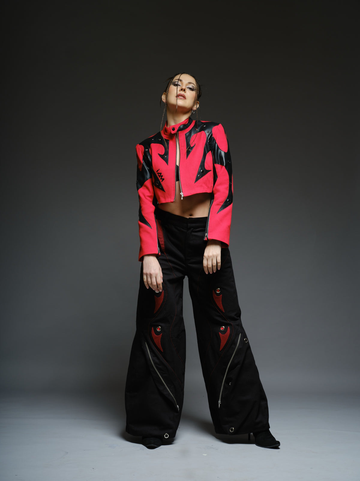 Red denim jacket with pointed black leather patches, mixed-size metal hardware, front zipper and sleeve zippers