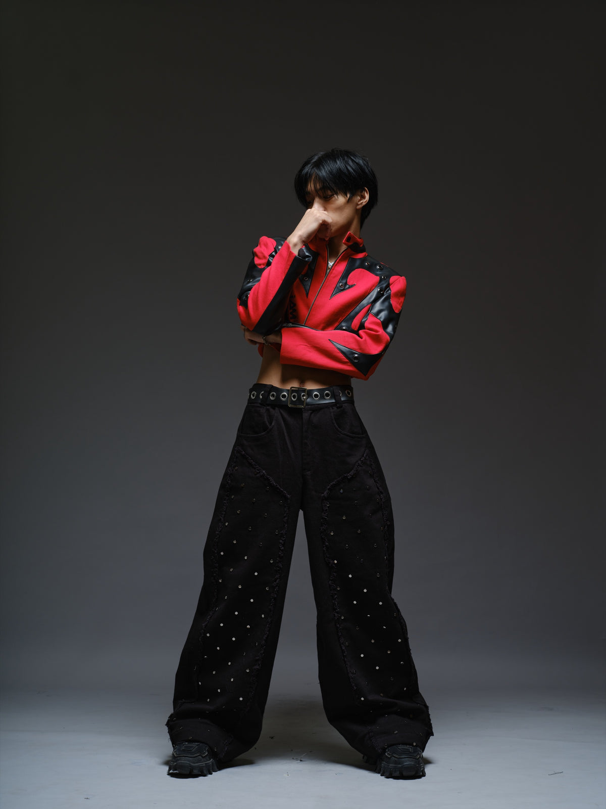 Red denim jacket with pointed black leather patches, mixed-size metal hardware, front zipper and sleeve zippers
