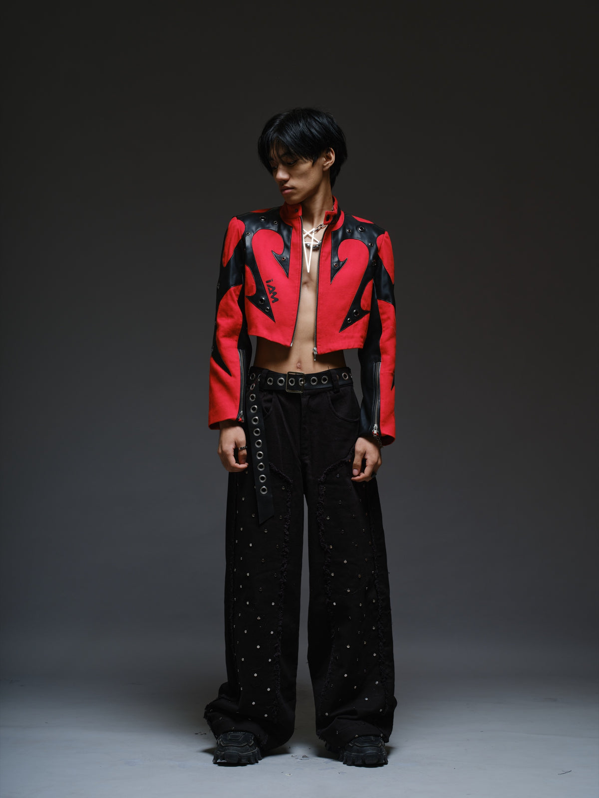Red denim jacket with pointed black leather patches, mixed-size metal hardware, front zipper and sleeve zippers