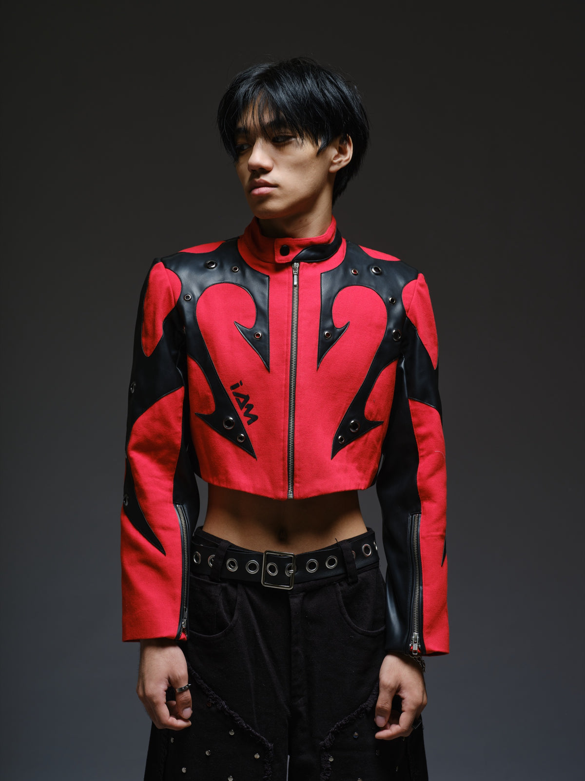 Red denim jacket with pointed black leather patches, mixed-size metal hardware, front zipper and sleeve zippers