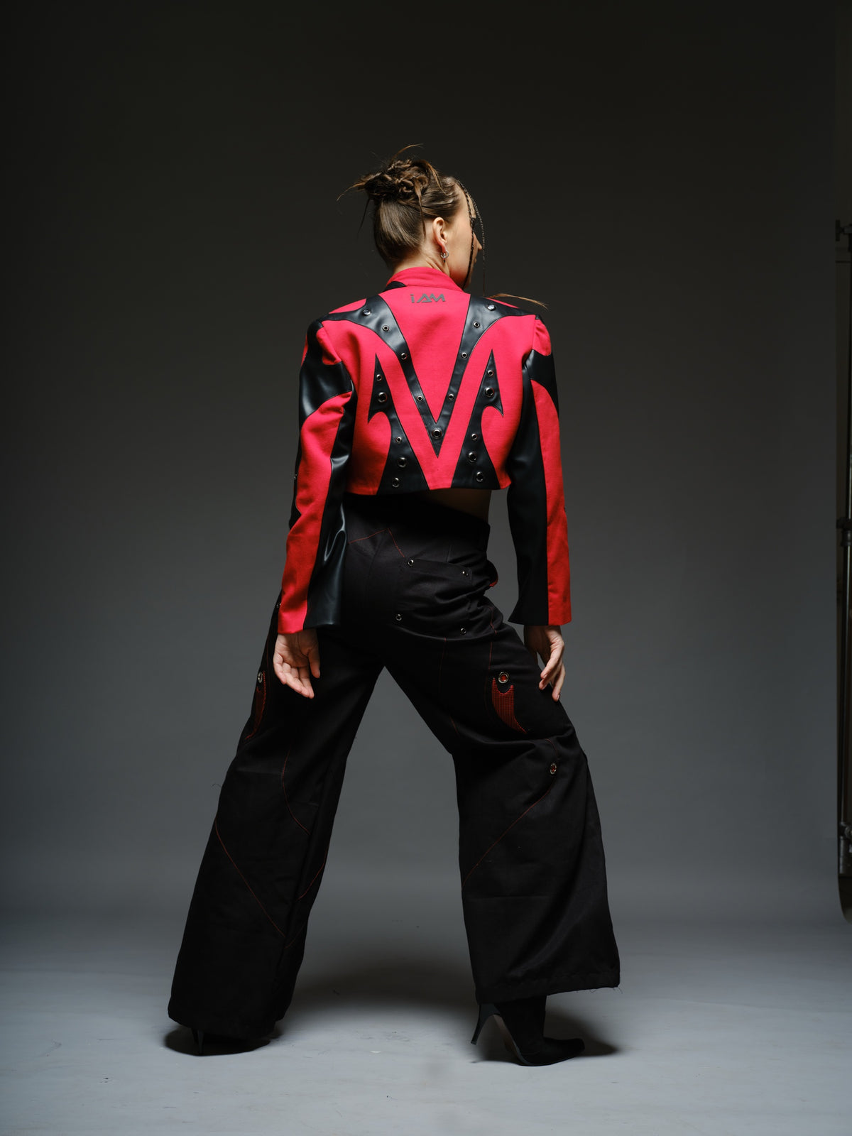 Red denim jacket with pointed black leather patches, mixed-size metal hardware, front zipper and sleeve zippers