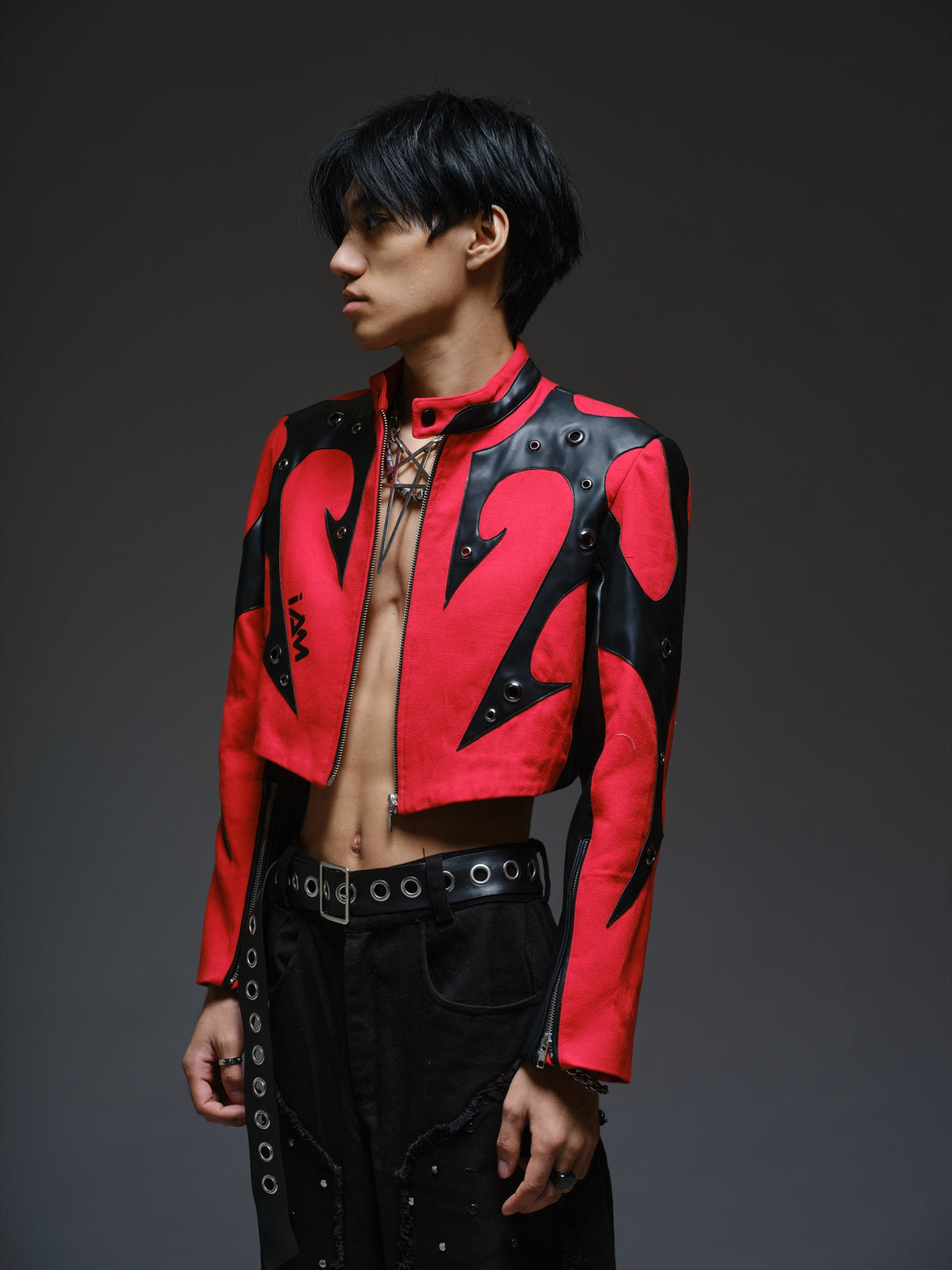 Red denim jacket with pointed black leather patches, mixed-size metal hardware, front zipper and sleeve zippers