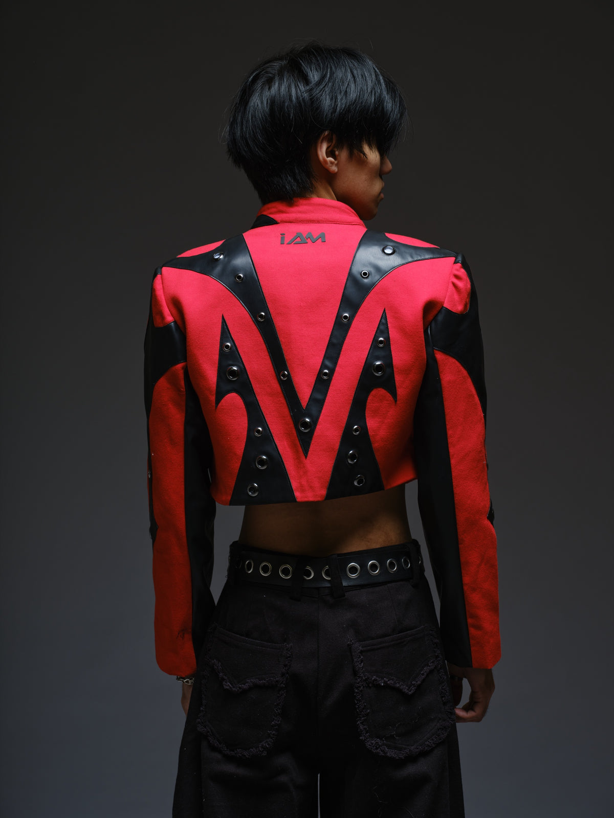 Red denim jacket with pointed black leather patches, mixed-size metal hardware, front zipper and sleeve zippers