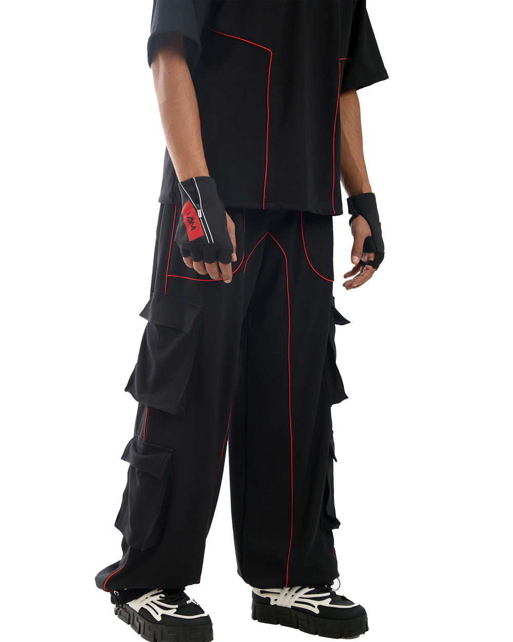 Techno Parachute Pants: Black, loose-fitting pants with multiple pockets and drawstring details.