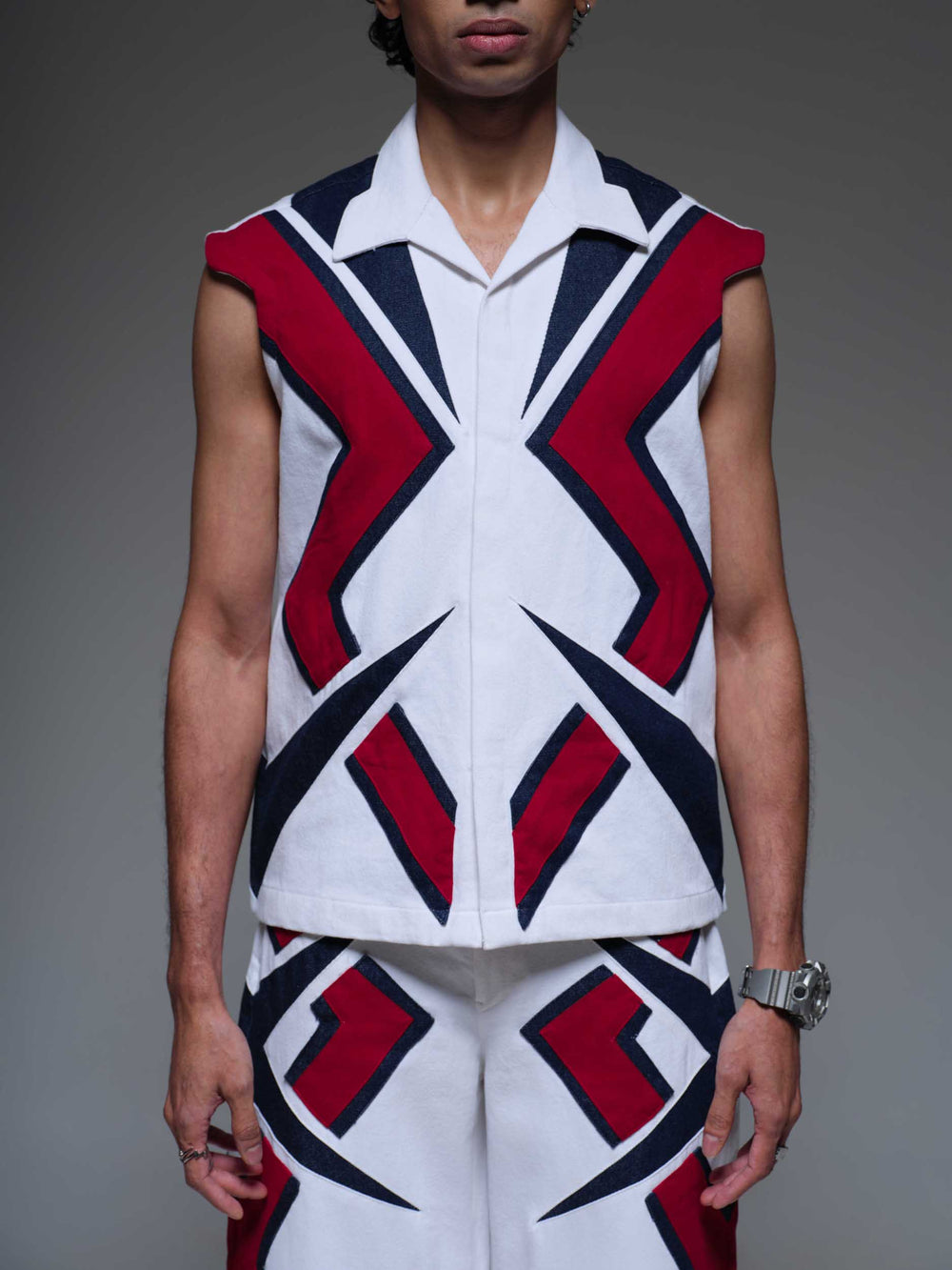 MAZE MATRIX VEST: A black, sleeveless vest with a geometric maze pattern in white and grey.