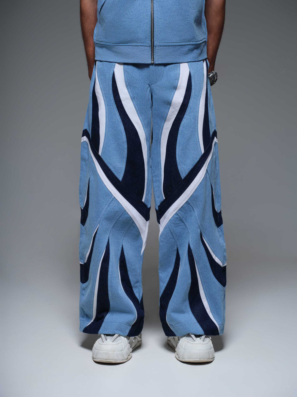 ECLIPSE FLAME PANTS: black pants with a vibrant, fiery red and orange flame pattern on the legs.
