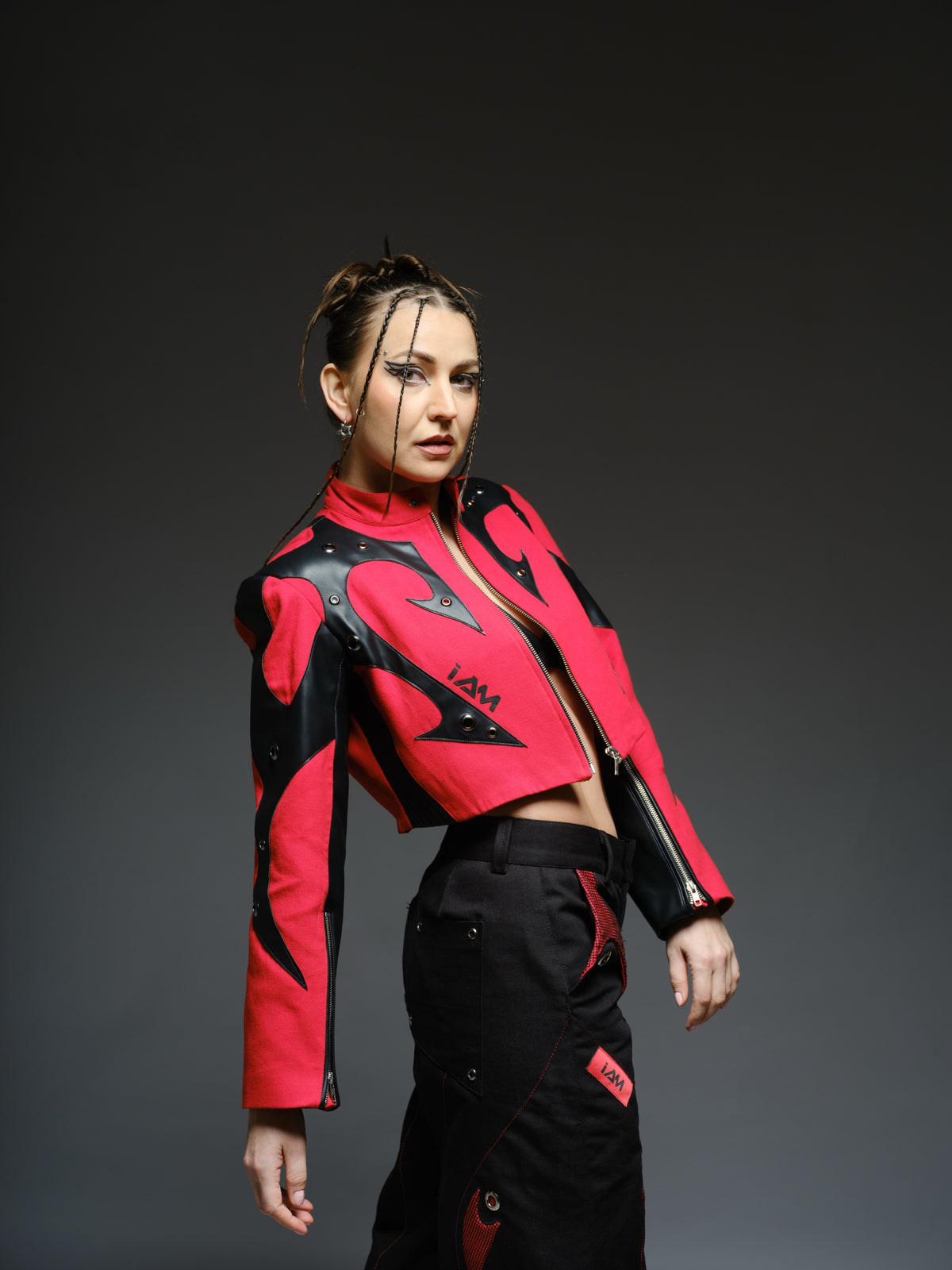 Red denim jacket with pointed black leather patches, mixed-size metal hardware, front zipper and sleeve zippers