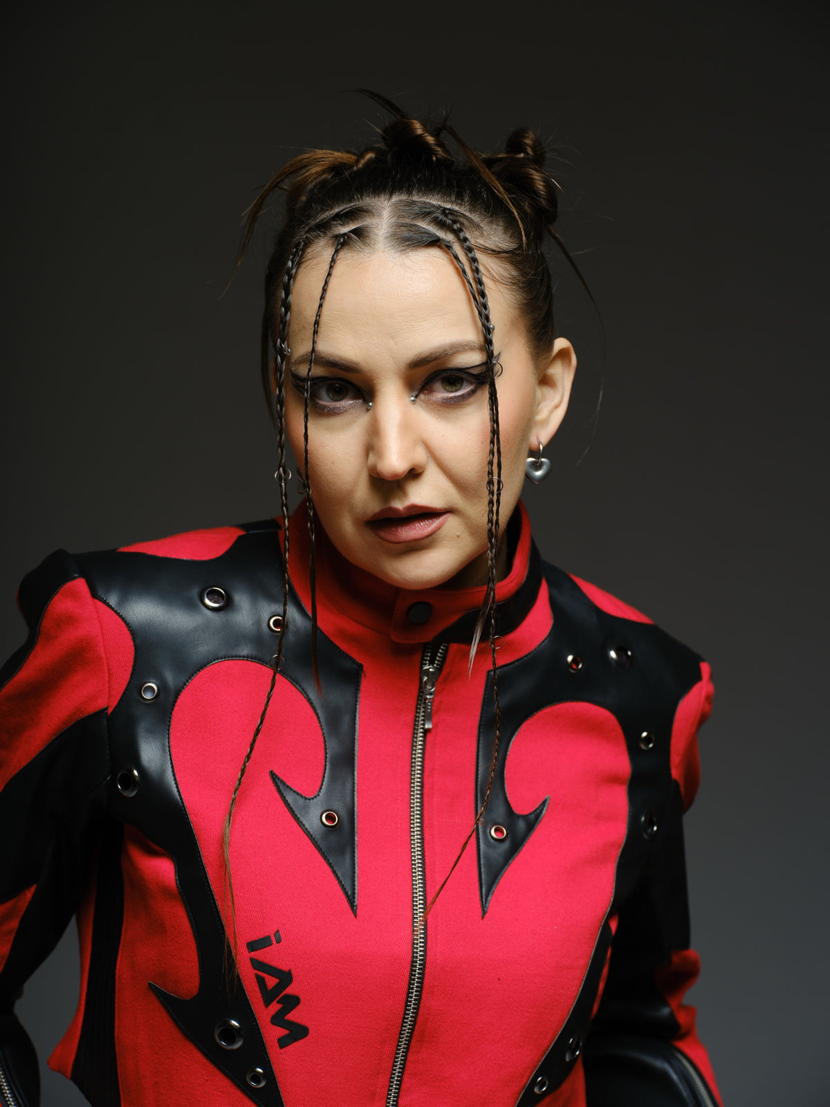 Red denim jacket with pointed black leather patches, mixed-size metal hardware, front zipper and sleeve zippers