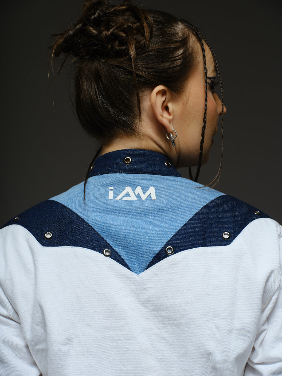 White and blue panelled denim cropped jacket and A-line skirt with metal rivets and criss-cross cord detailing