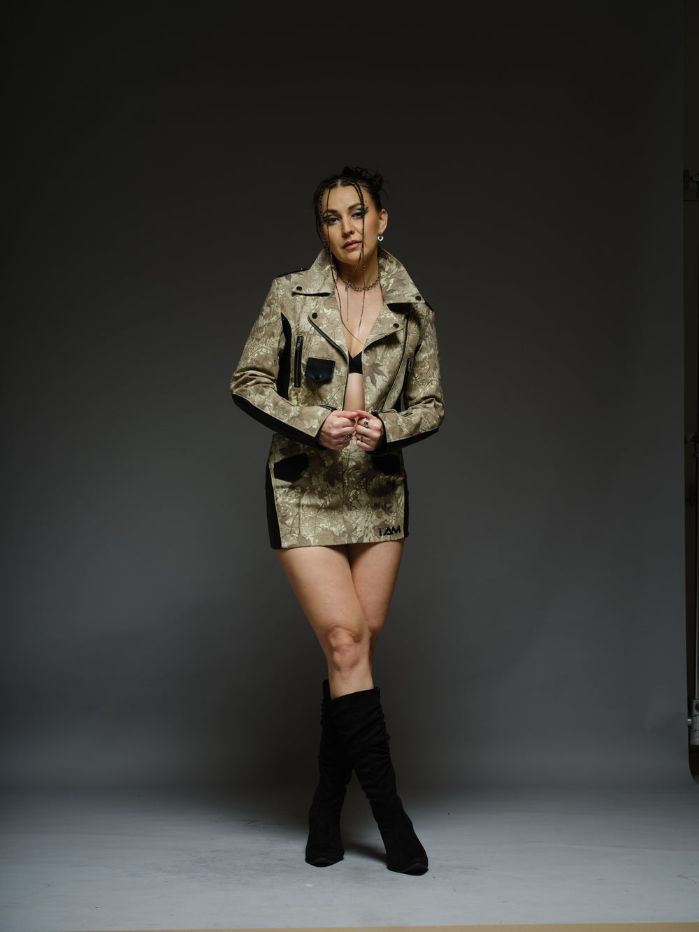 Camouflage-style denim cropped biker jacket and mini skirt with black ribbed leather panels and metal hardware