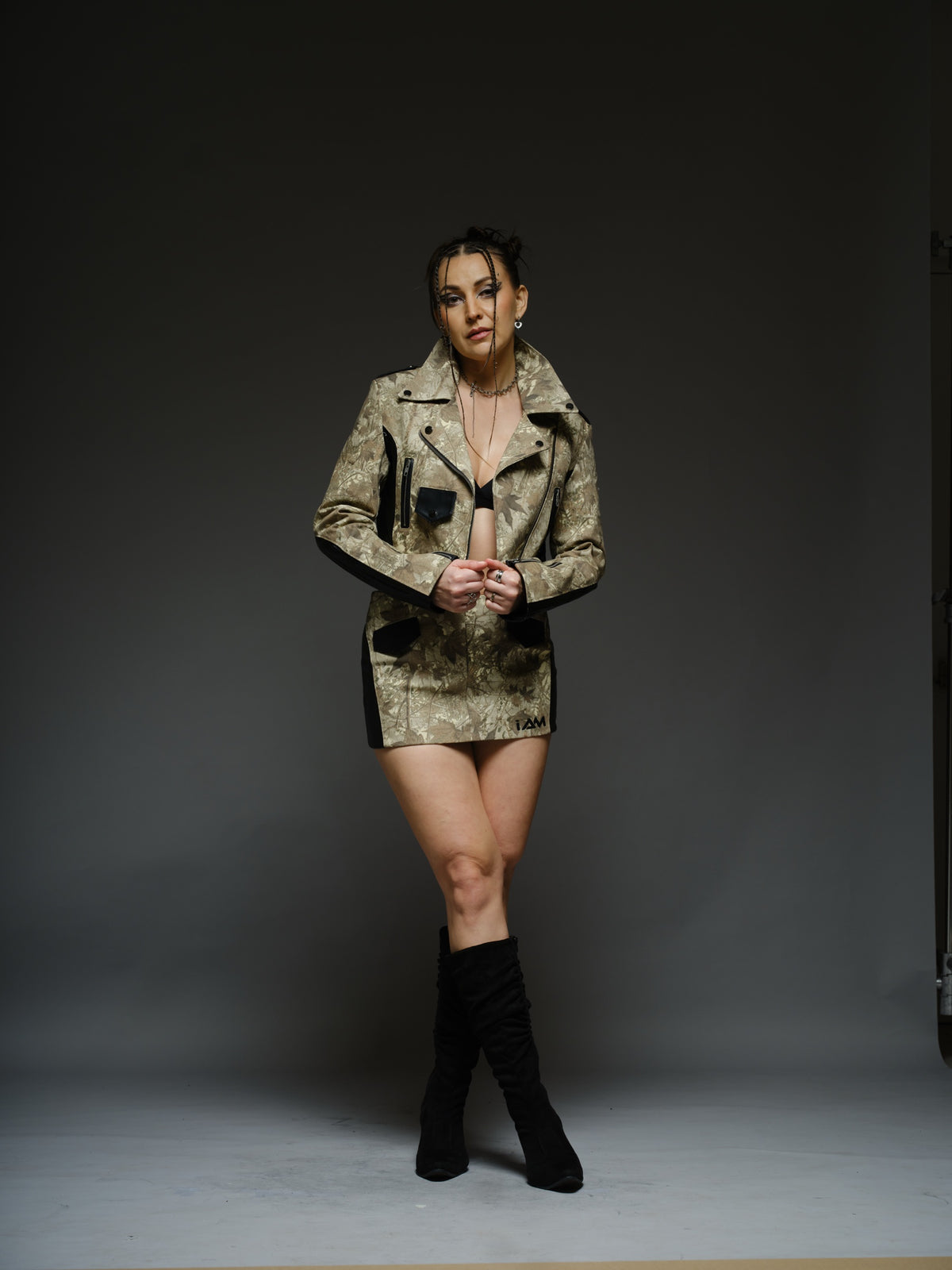 Camouflage-style denim cropped biker jacket and mini skirt with black ribbed leather panels and metal hardware
