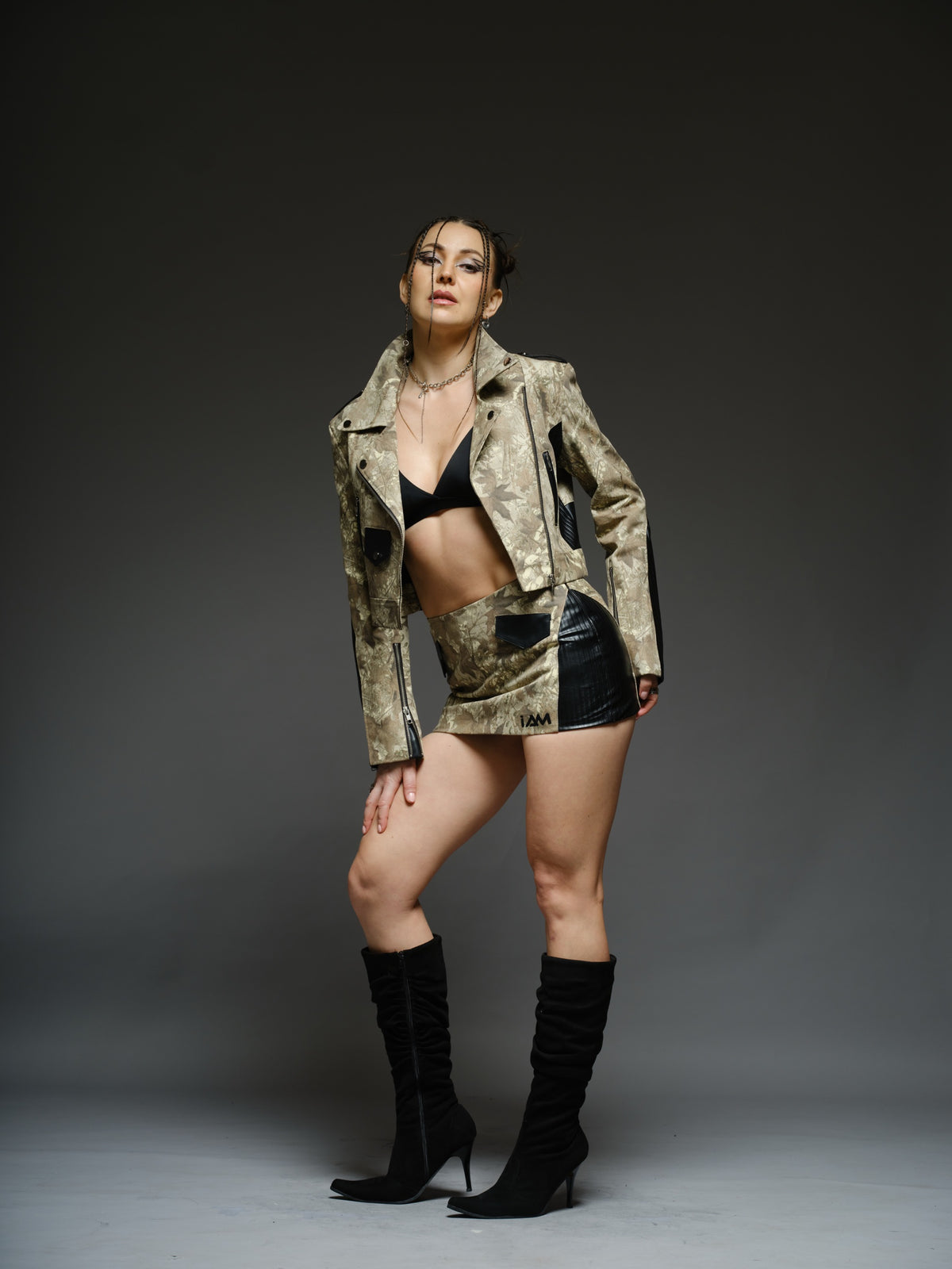 Camouflage-style denim cropped biker jacket and mini skirt with black ribbed leather panels and metal hardware