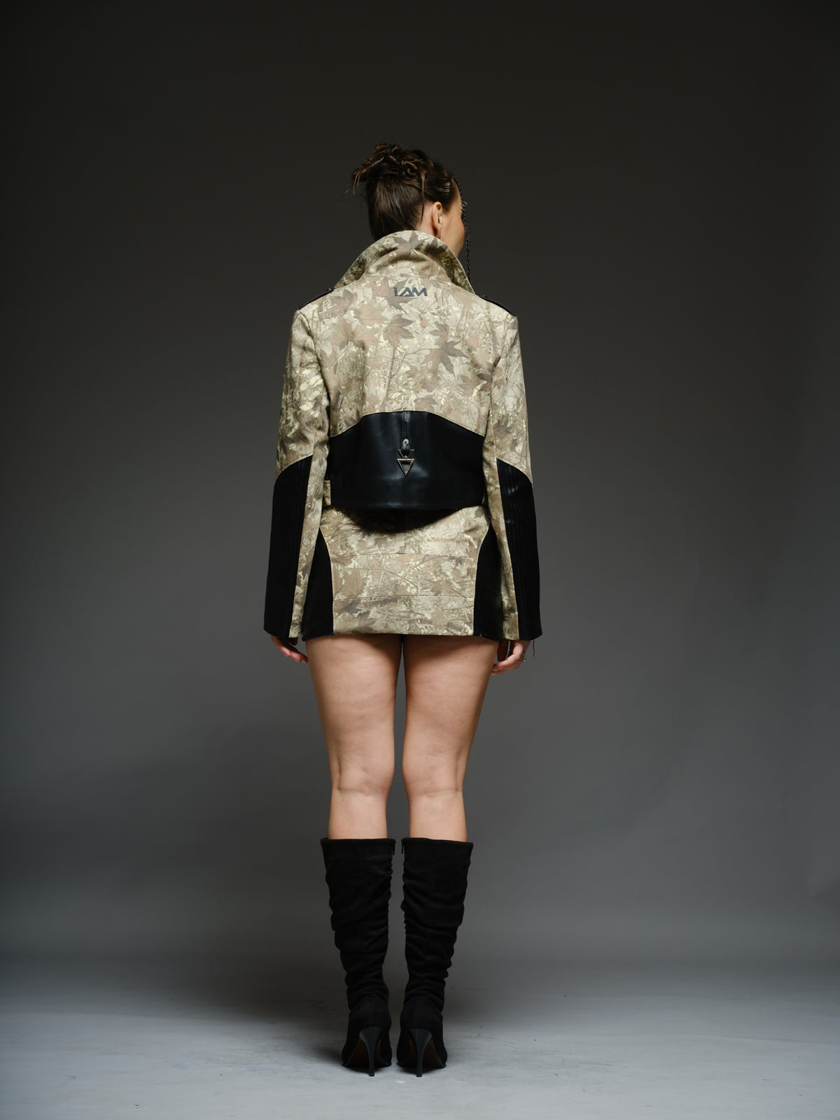Camouflage-style denim cropped biker jacket and mini skirt with black ribbed leather panels and metal hardware