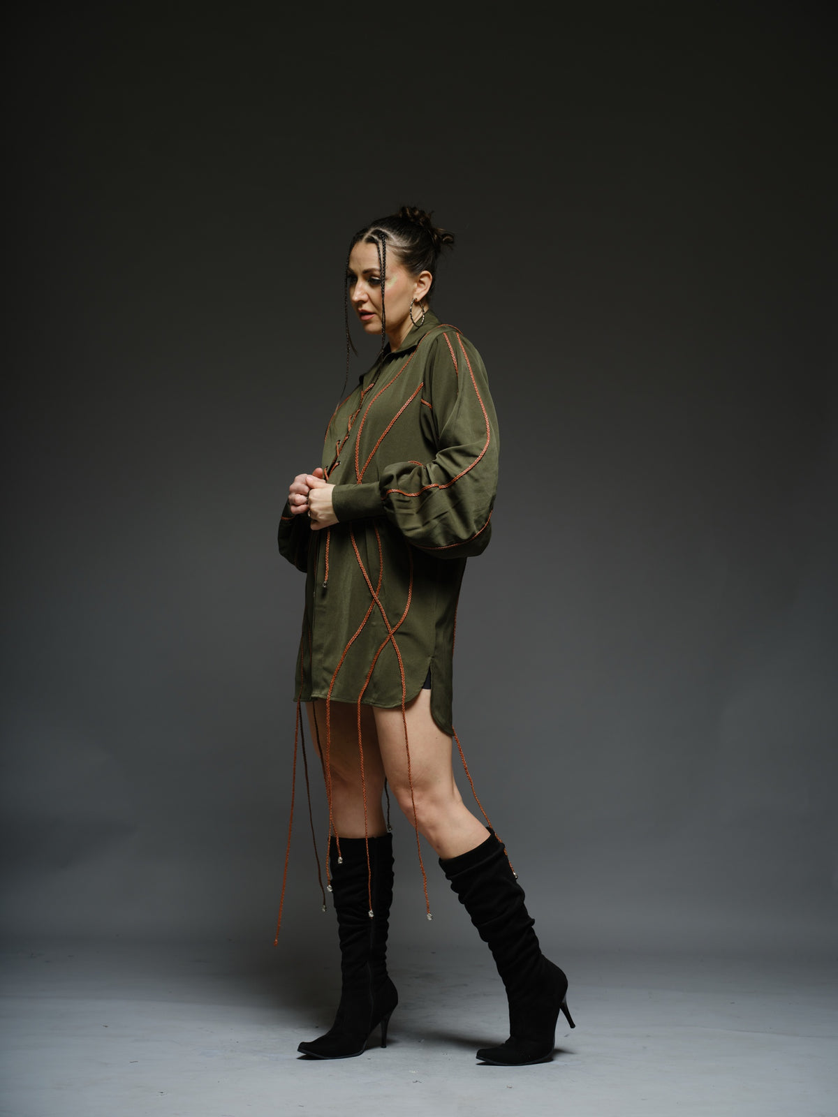Olive green shirt dress with balloon sleeves, front lacing and contrast braided cords extending below the hem