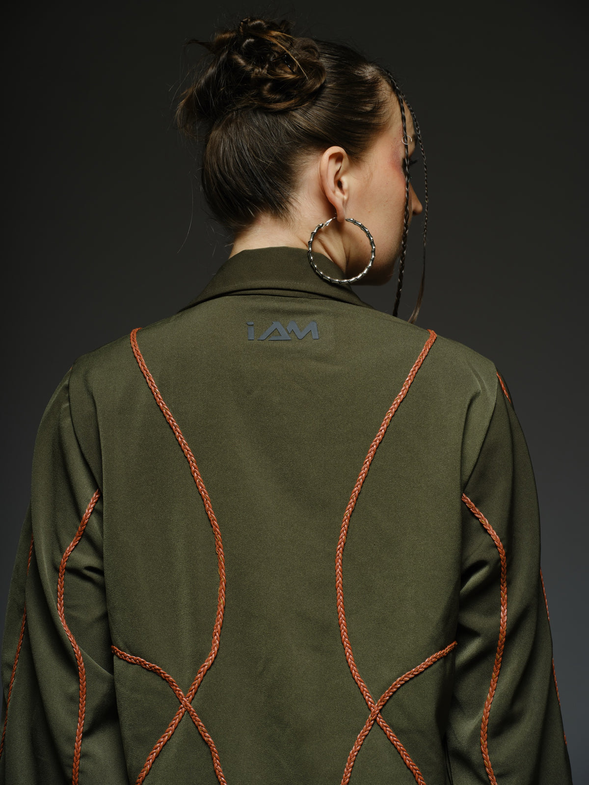 Olive green shirt dress with balloon sleeves, front lacing and contrast braided cords extending below the hem