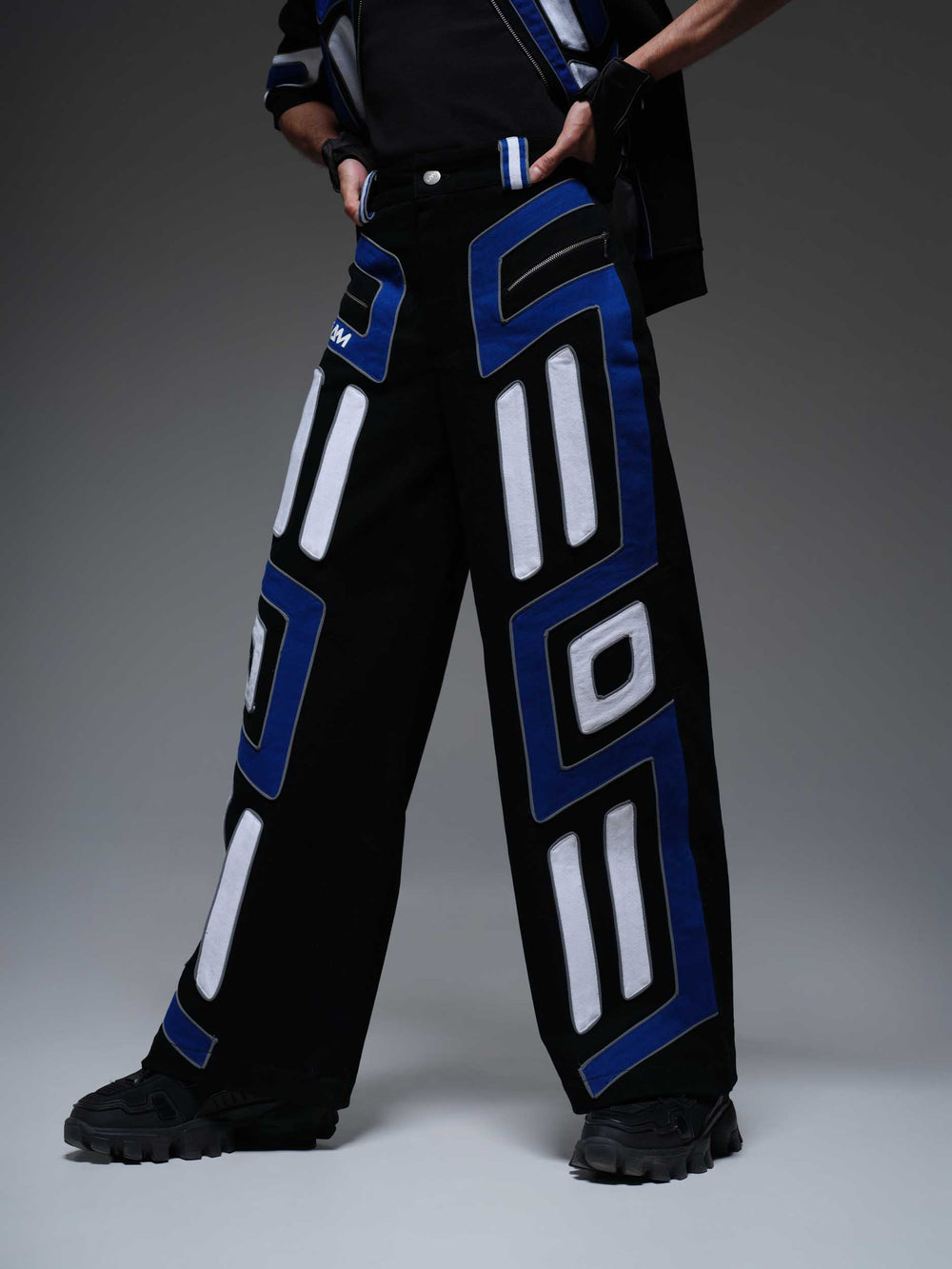 Black "Night Shifter Pants" with subtle grey stitching and a relaxed fit, shown laid flat.