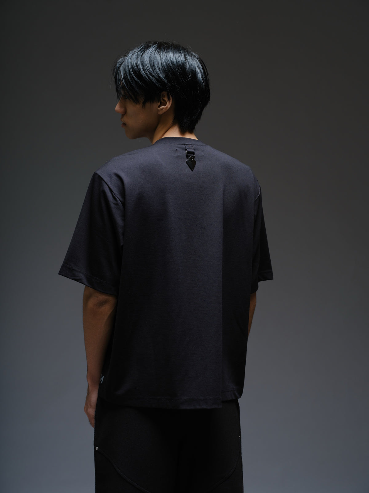 Black Roma knit short-sleeve tee with curved grey net panels across the shoulders and front