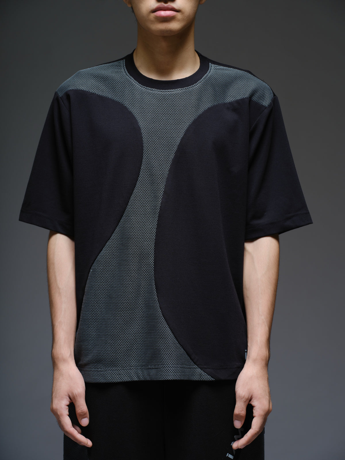 Black Roma knit short-sleeve tee with curved grey net panels across the shoulders and front