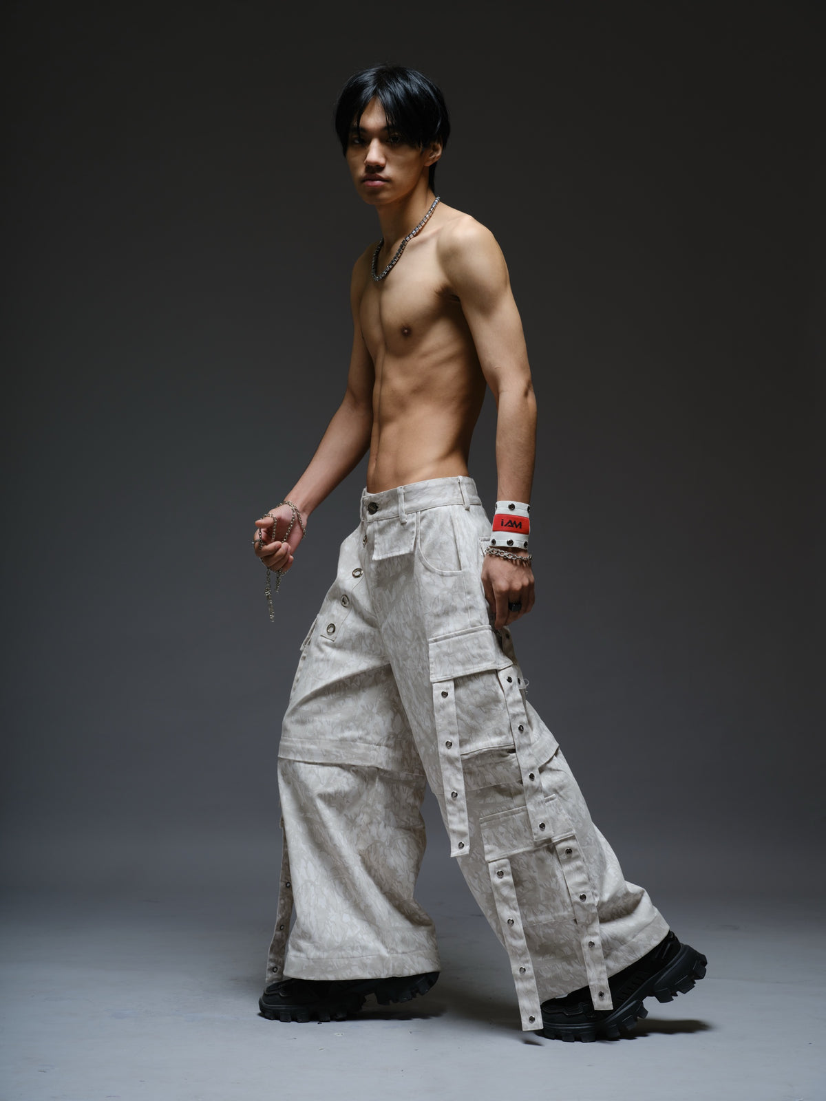 Printed camo denim cargo pants with detachable lower legs, oversized flap pockets and hanging straps