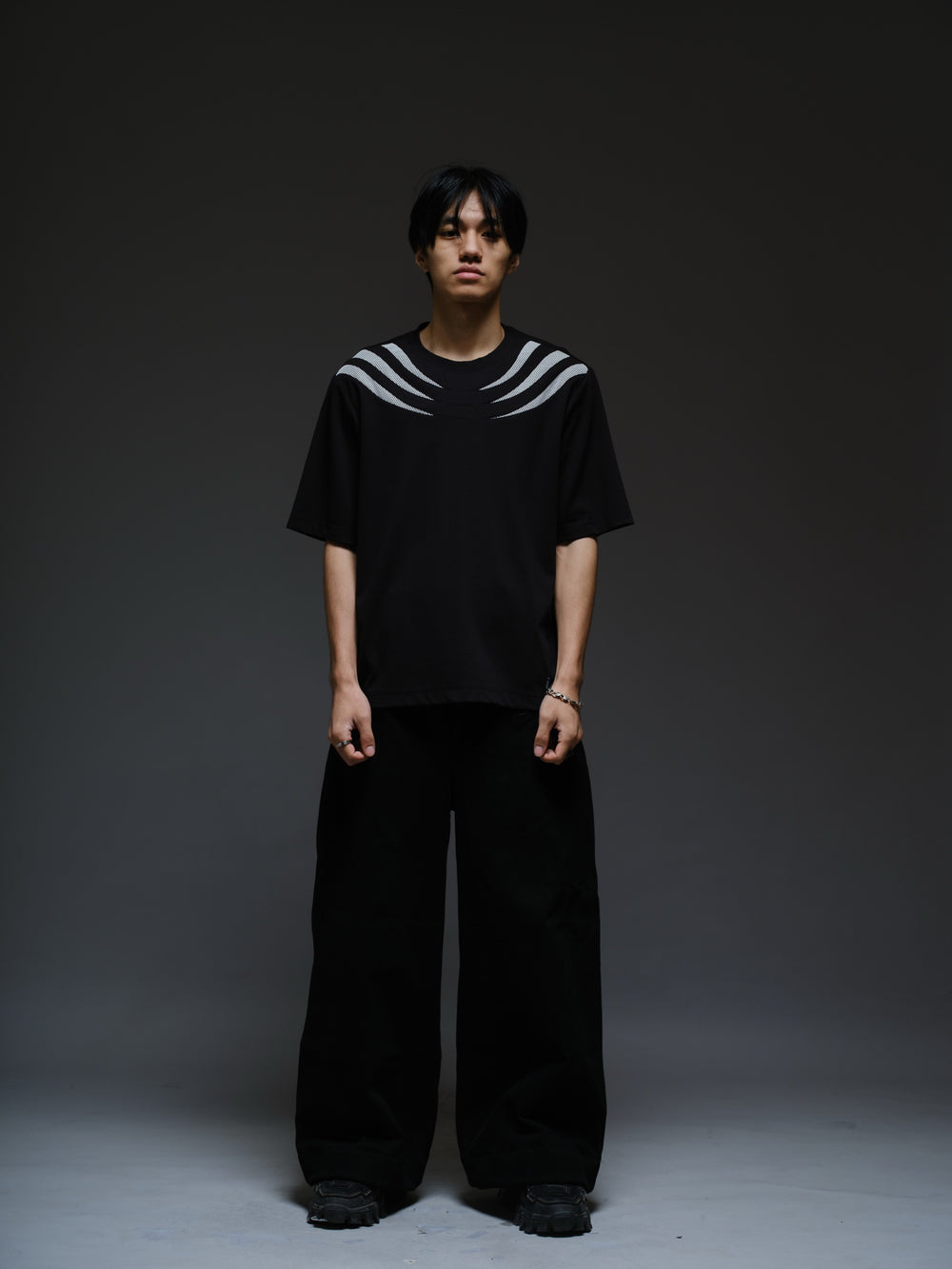 Relaxed black Roma knit tee with white net panels across the shoulders and upper chest