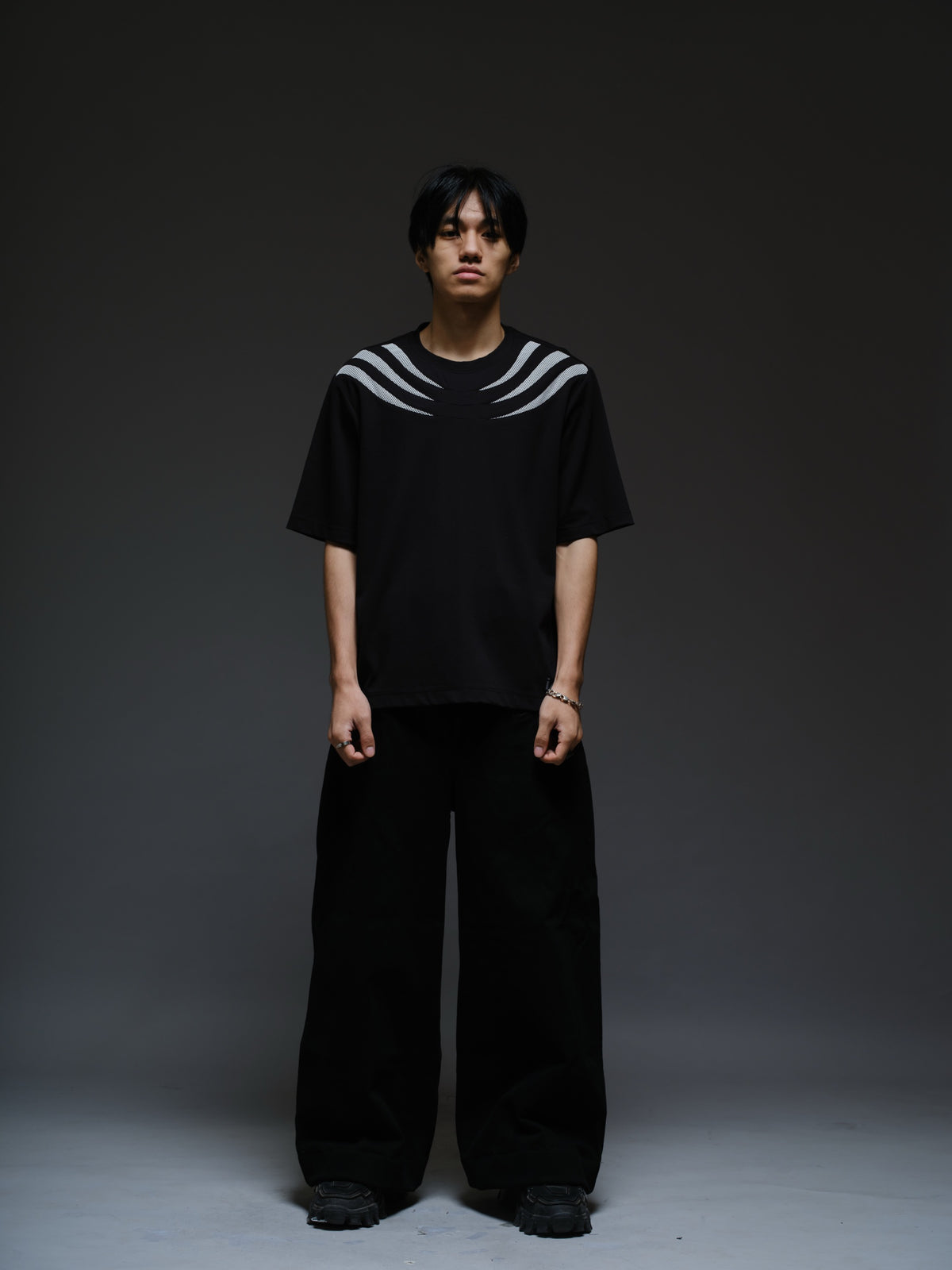 Relaxed black Roma knit tee with white net panels across the shoulders and upper chest