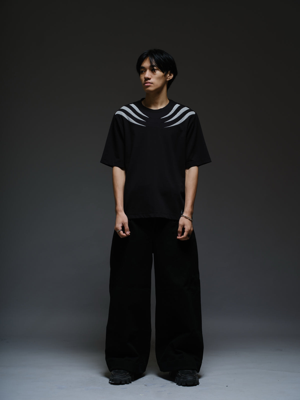 Relaxed black Roma knit tee with white net panels across the shoulders and upper chest