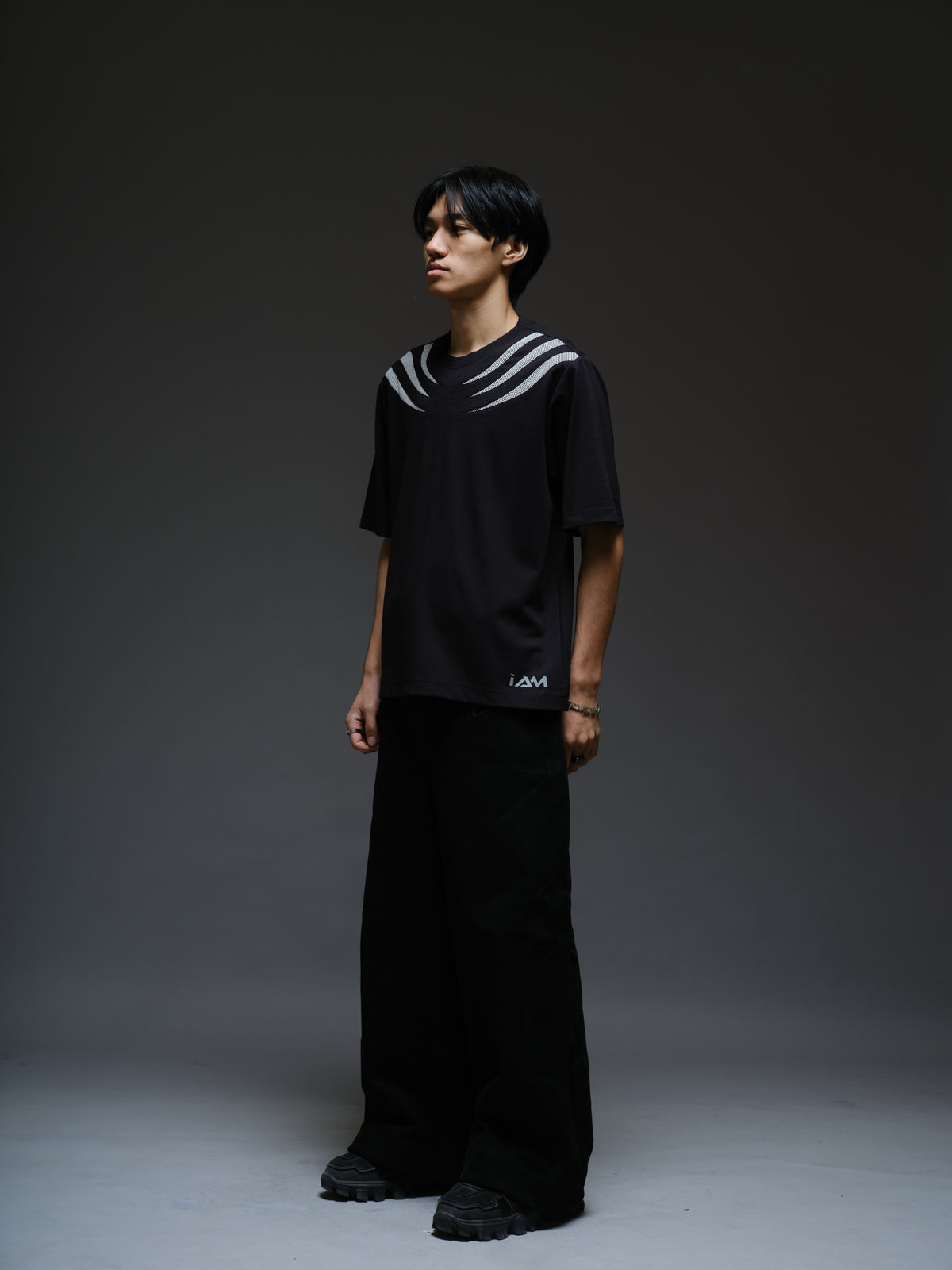 Relaxed black Roma knit tee with white net panels across the shoulders and upper chest