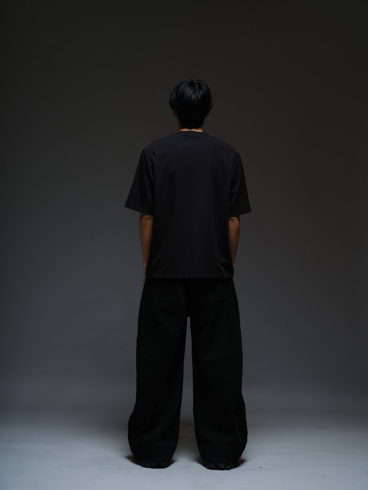 Relaxed black Roma knit tee with white net panels across the shoulders and upper chest