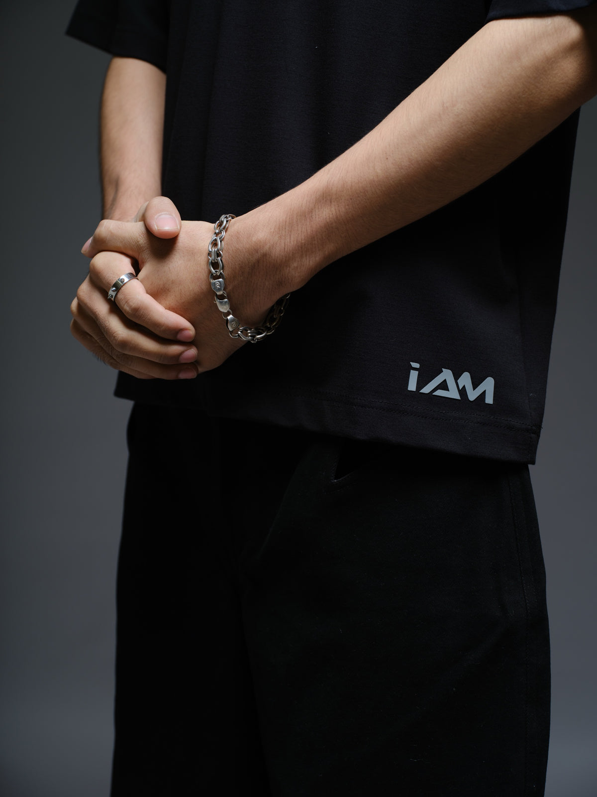 Relaxed black Roma knit tee with white net panels across the shoulders and upper chest