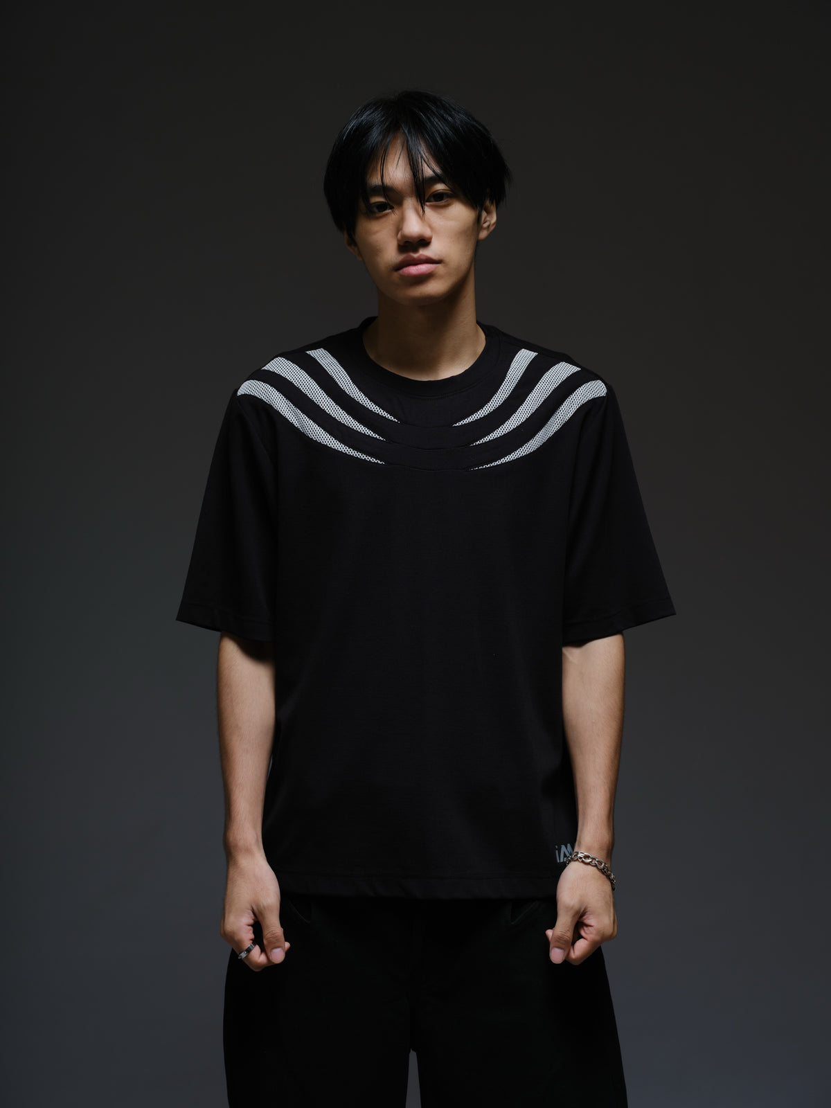 Relaxed black Roma knit tee with white net panels across the shoulders and upper chest