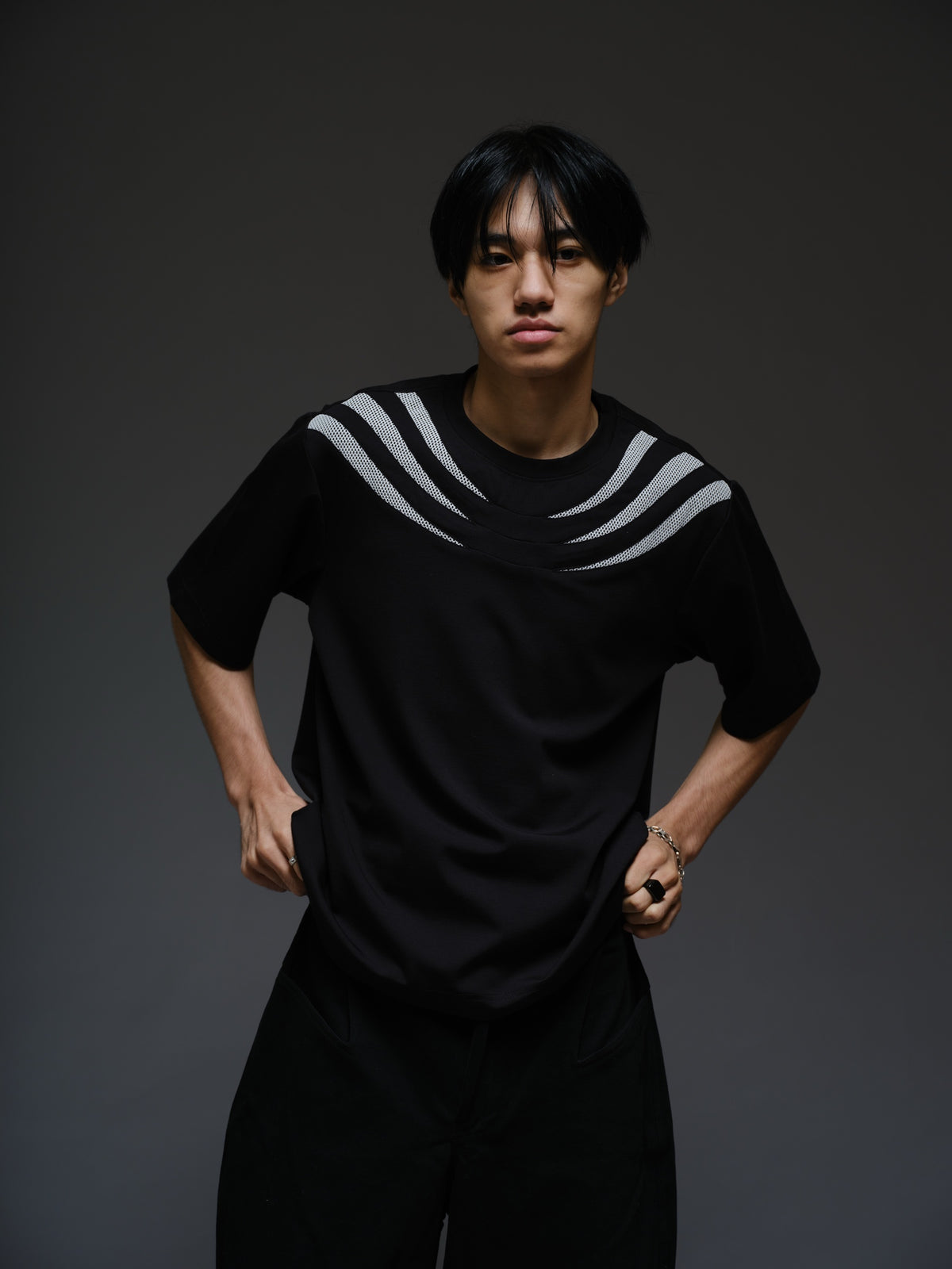 Relaxed black Roma knit tee with white net panels across the shoulders and upper chest