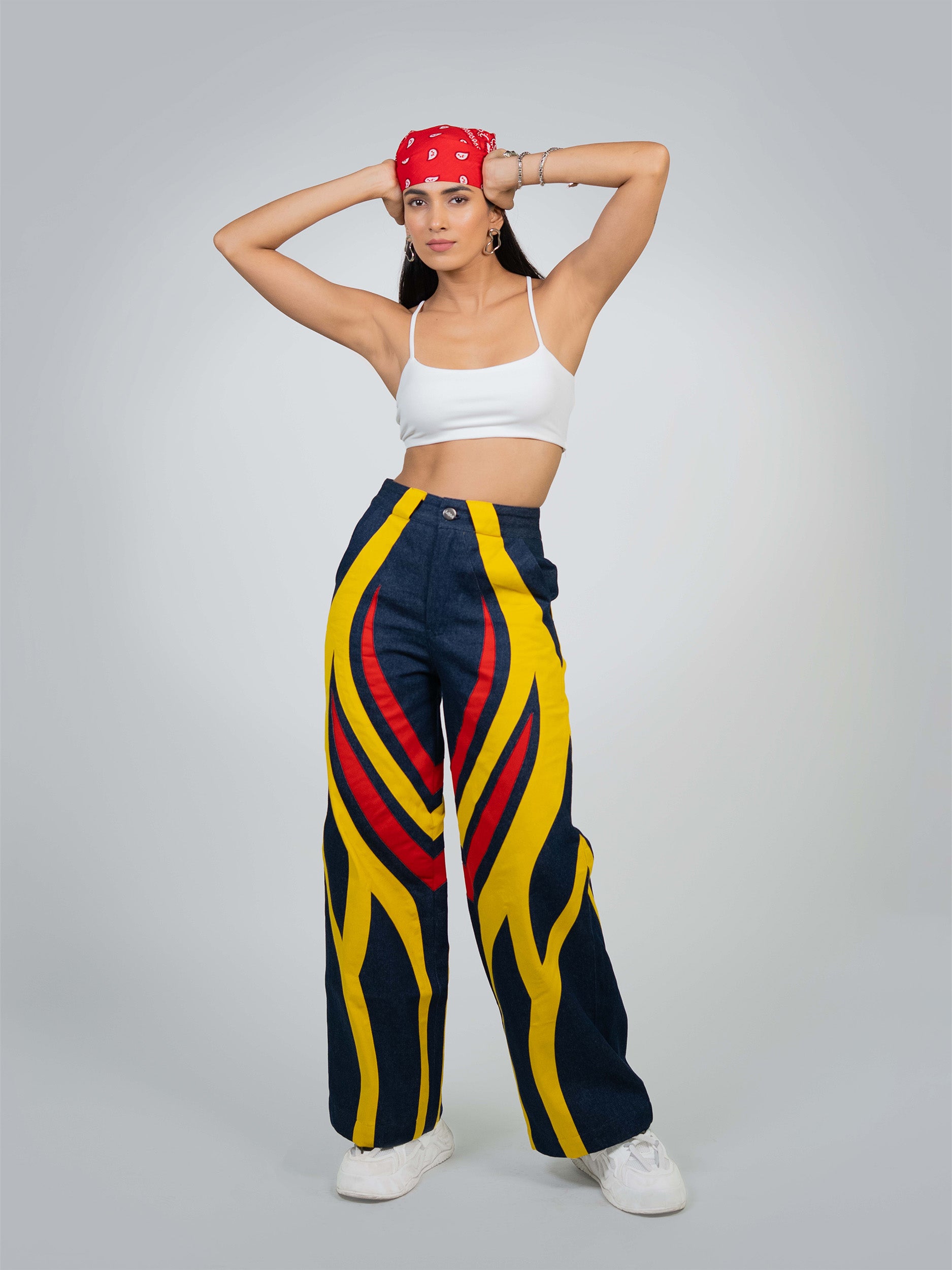 Close-up of Blaze Bull Pants, showing durable denim fabric with red stitching and a subtle bull logo patch.