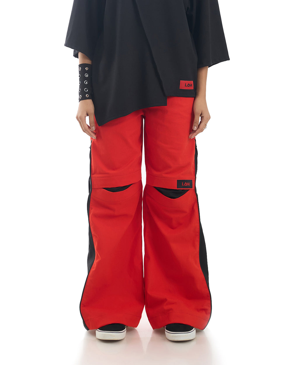 Close-up of Hot Red Zipper Pants, showcasing the vibrant color and detailed zipper accents.